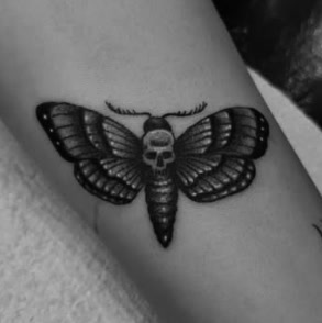Black and grey deaths-head moth tattoo